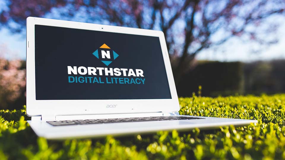 laptop on grass with Northstar Digital Literacy logo