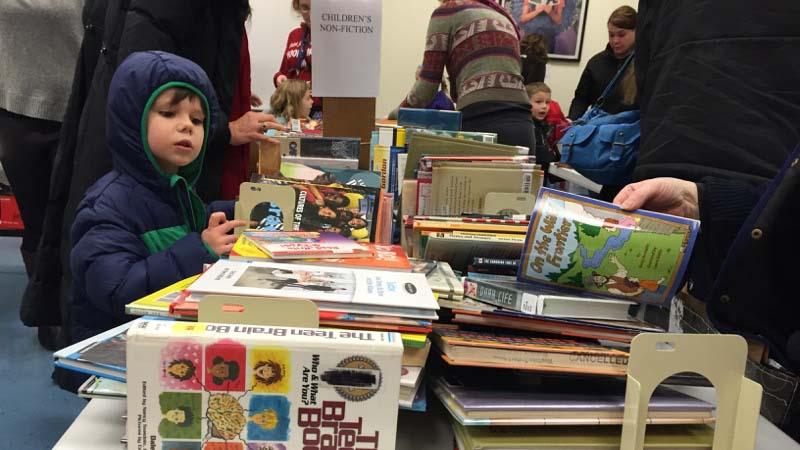 Patrons peruse children's books for sale in 2015